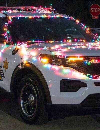 A CCSPD squad car decorated in Christmas lights