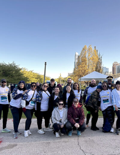 A group photo with an officer and several marathon runners