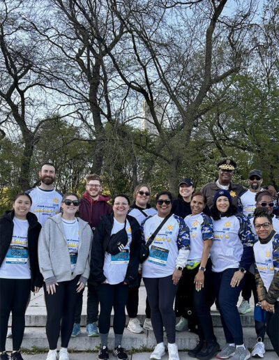 A group photo with an officer and several marathon runners