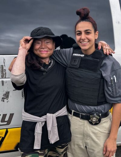 OFFICER NADIA SHEHADEH POSES WITH FLACCA FROM THE HOMELESS ENCAMPMENT ON 31ST CICERO AFTER HANDING OUT CARE PACKAGES