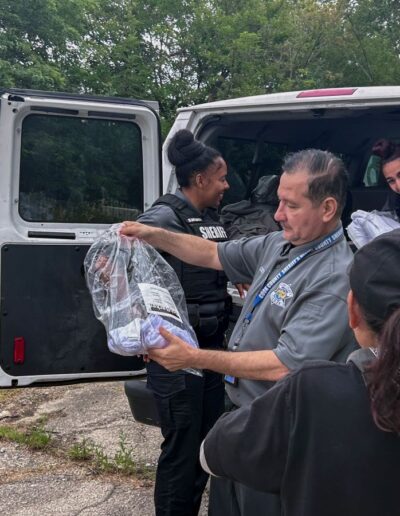 SHARP RESEARCH COORDINATOR SERGIO CISNEROS HANDS OUT CARE PACKAGES TO INDIVIDUALS IN HOMELESS ENCAMPMENT ON 31ST CICERO